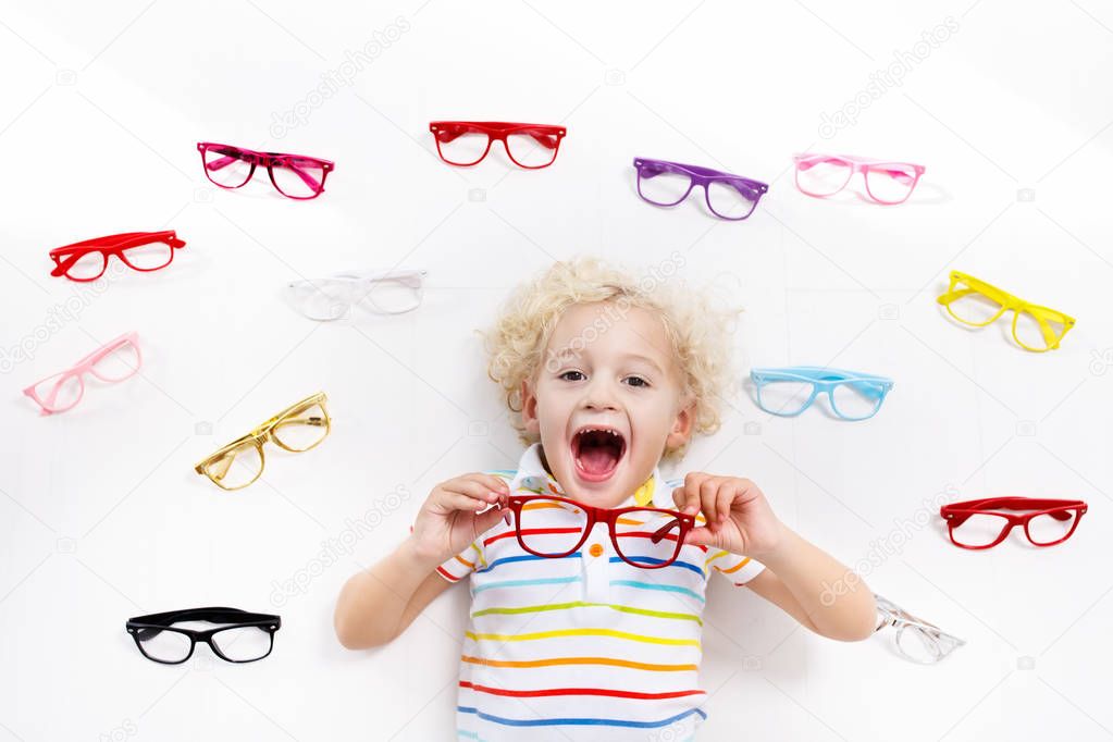 Child at eye sight test. Kid at optitian. Eyewear for kids.