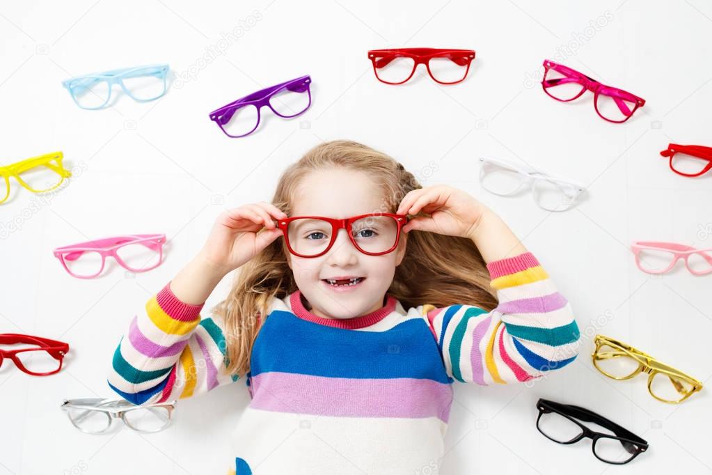 Child at eye sight test. Kid at optitian. Eyewear for kids.