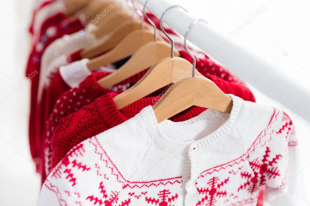 Clothes rack with red Christmas knit wear