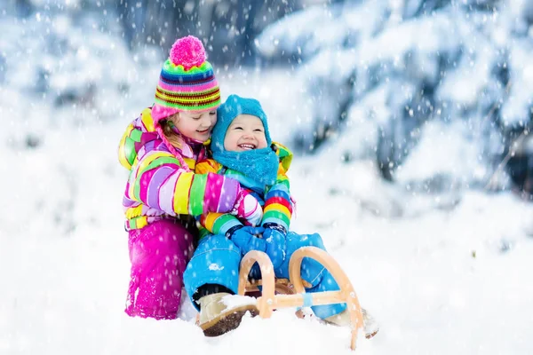 Kinder auf Schlittenfahrt. Kinderrodeln. Winterspaß im Schnee. — Stockfoto