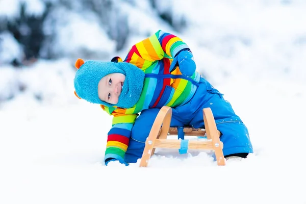 Junge auf Schlittenfahrt. Kinderrodeln. Kind mit Schlitten — Stockfoto