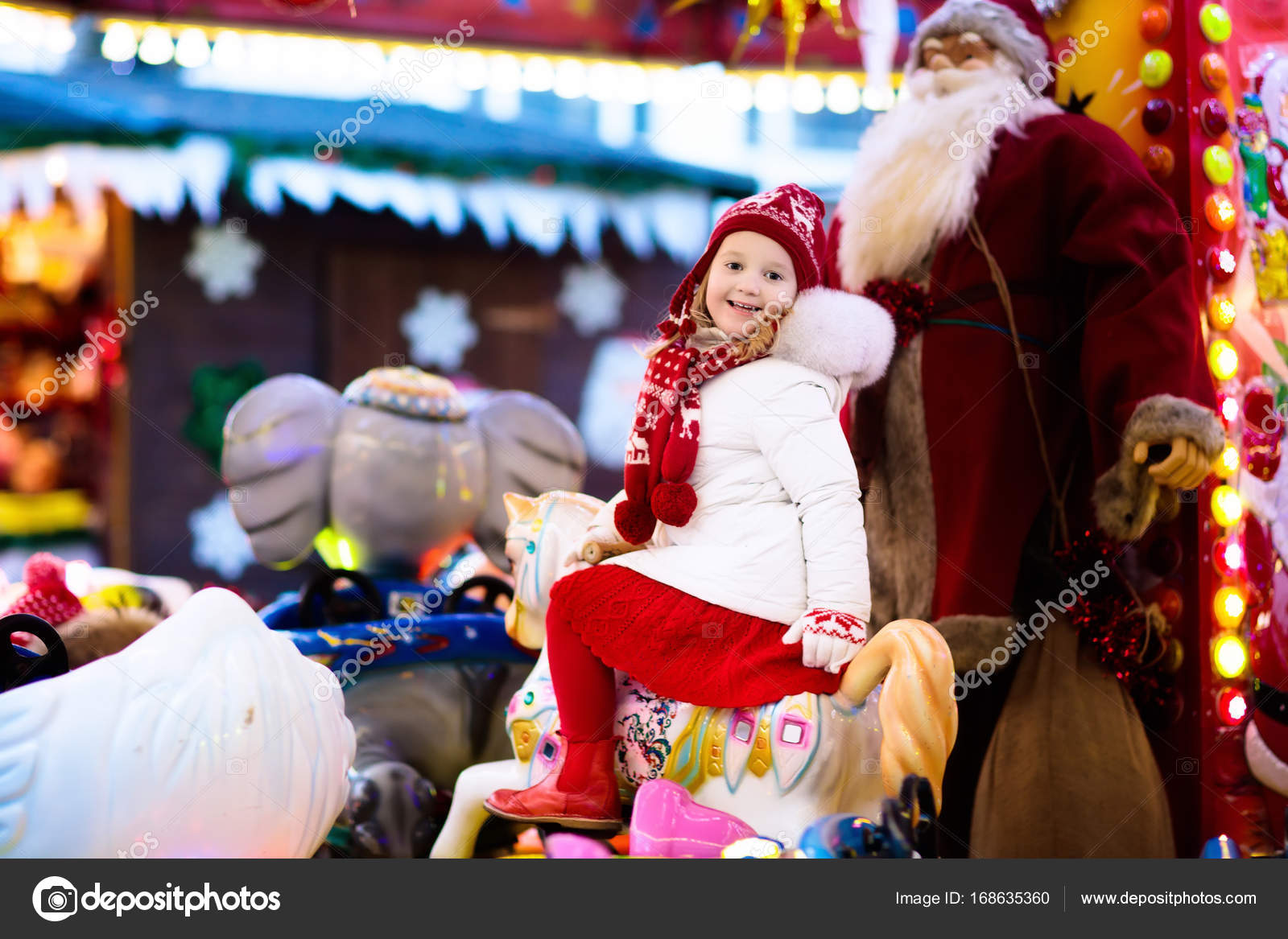 Child On Christmas Fair Kid Riding Xmas Carousel Stock Photo
