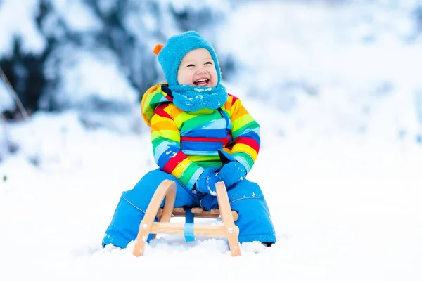 Boy on sleigh ride. Child sledding. Kid with sledge — Stock Photo, Image