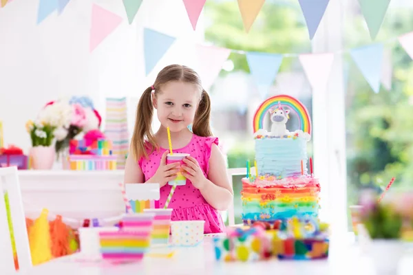 Kids birthday party. Little girl with cake.