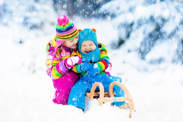 Kids on sleigh ride. Children sledding. Winter snow fun. — Stock Photo, Image