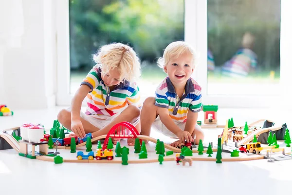 Children play wiht toy train. Kids wooden railway. — Stock Photo, Image