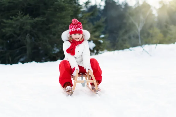 Child sledding. Kid with sledge. Winter snow fun. — Stock Photo, Image