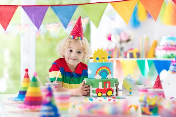 Kids birthday party. Child blowing out cake candle — Stock Photo, Image