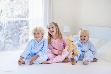 Yatakta evlat. Kış penceresi. Çocuk evde kar tarafından.