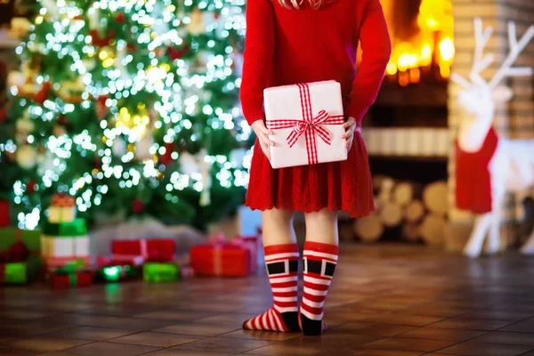 Child at Christmas tree. Kid at fireplace on Xmas — Stock Photo, Image