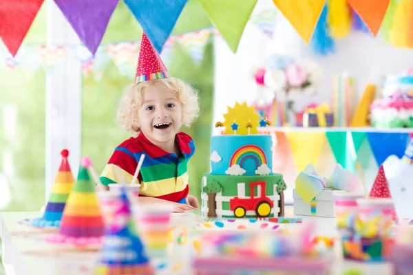 Kids birthday party. Child blowing out cake candle — Stock Photo, Image