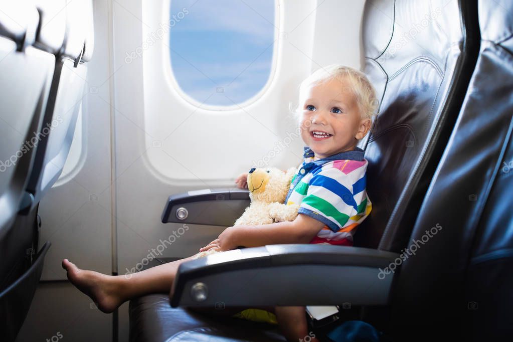 Child flying in airplane.Flight with kids.