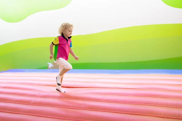 Child jumping on playground trampoline. Kids jump. — Stock Photo, Image
