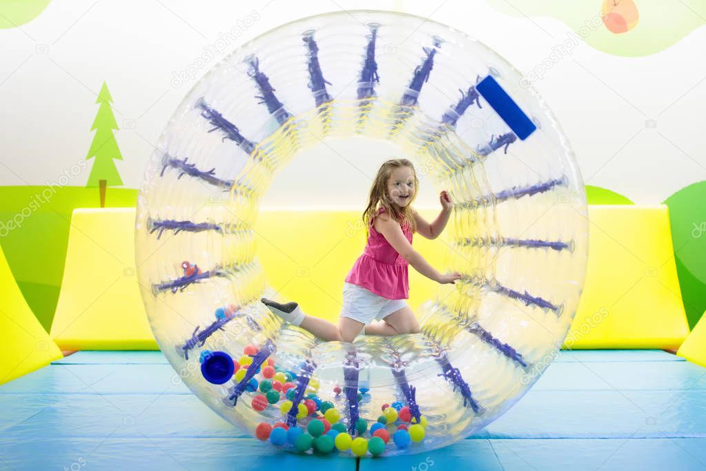 Child play in roller wheel. Kids on trampoline. 