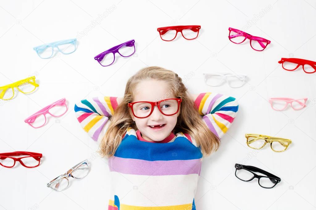 Child at eye sight test. Kid at optitian. Eyewear for kids.