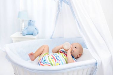 Bebek süt içme. Yatakta formül şişe çocukla
