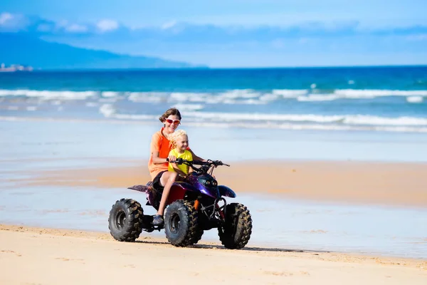 Kids on quad bike. Off road all terrain vehicle. — Stock Photo, Image