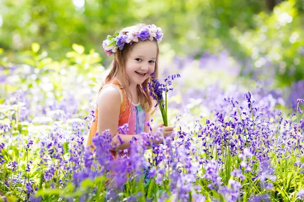 Kids in bluebell garden — Stock Photo, Image