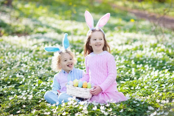 Dzieci z bunny uszy na Easter egg hunt. — Zdjęcie stockowe