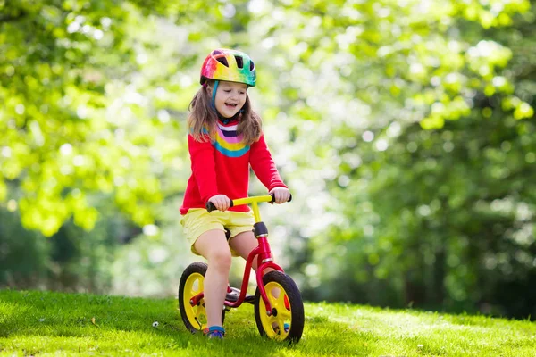 Kids ride balance bike in park