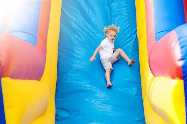Bambino che salta sul trampolino del parco giochi. I bambini saltano . — Foto Stock