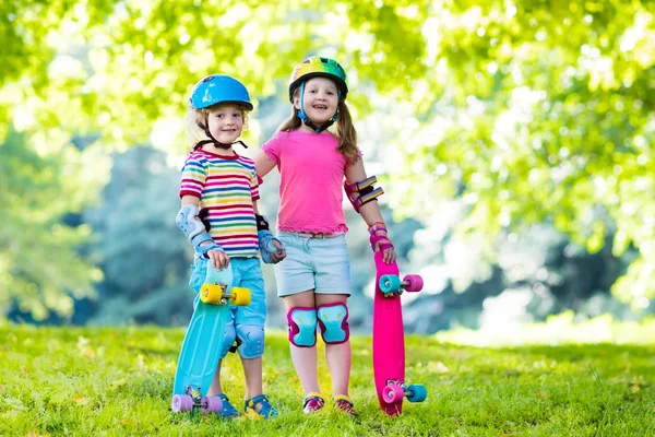 Barn ridning skateboard i sommaren park — Stockfoto