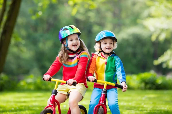 Kids ride balance bike in park — Stock Photo, Image