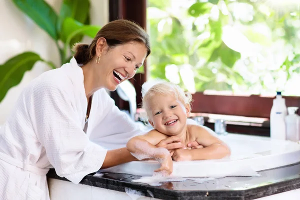 Mamma tvätt baby i bubbelbad. Vatten kul. — Stockfoto