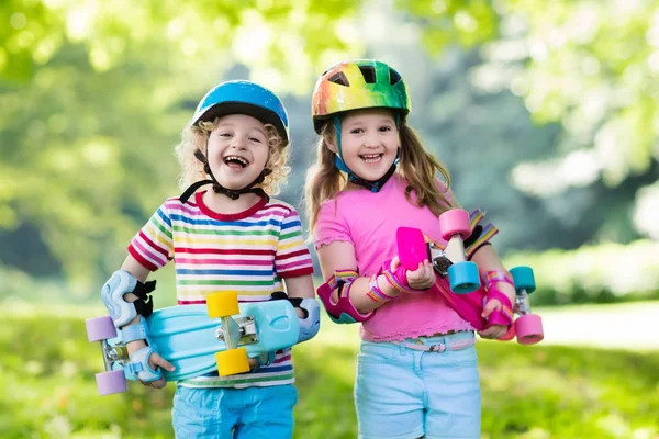 Niños montando monopatín en el parque de verano —  Fotos de Stock