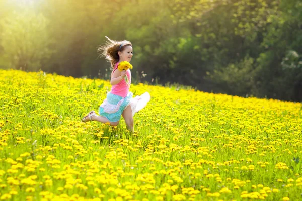 Kids play. Child in dandelion field. Summer flower — Stock Photo, Image