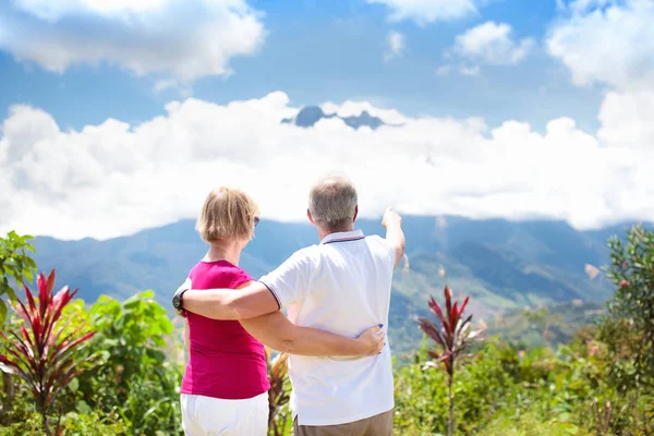 Senior couple hiking in mountains and jungle — Stock Photo, Image