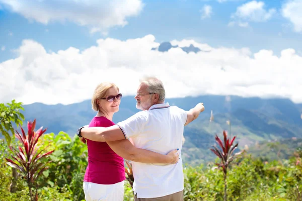 Senior couple hiking in mountains and jungle — Stock Photo, Image