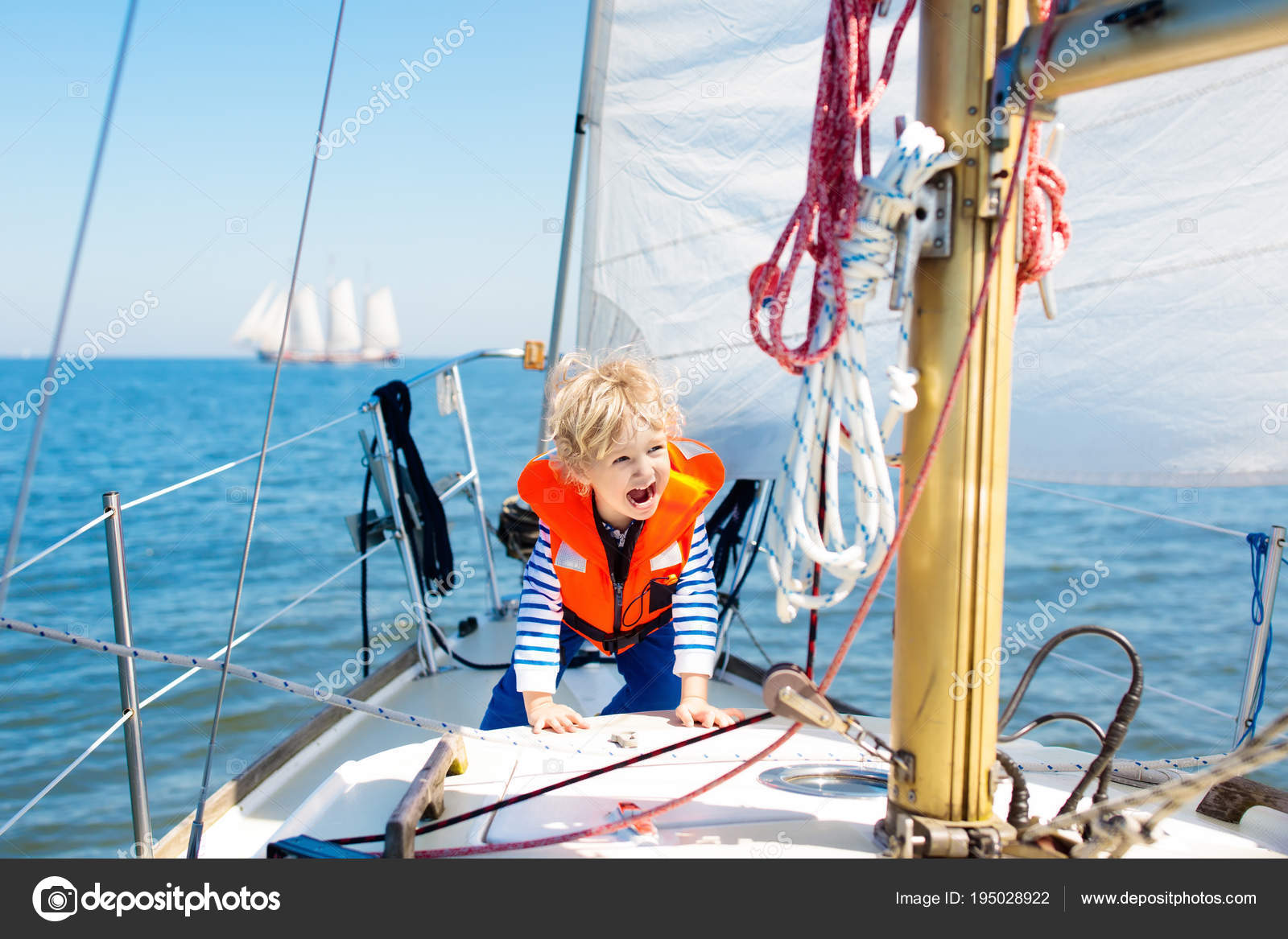 Kids sail on yacht in sea. Child sailing on boat. Stock Photo by