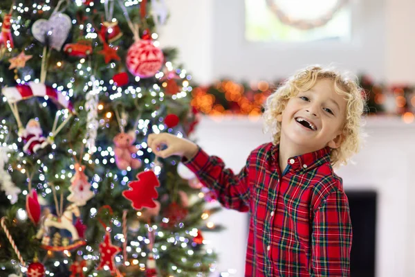 Kind schmückt Weihnachtsbaum. Kind an Heiligabend. — Stockfoto