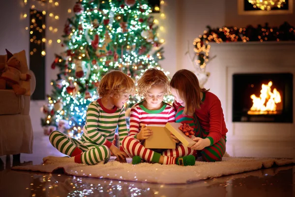 Child at Christmas tree. Kids at fireplace on Xmas — Stock Photo, Image