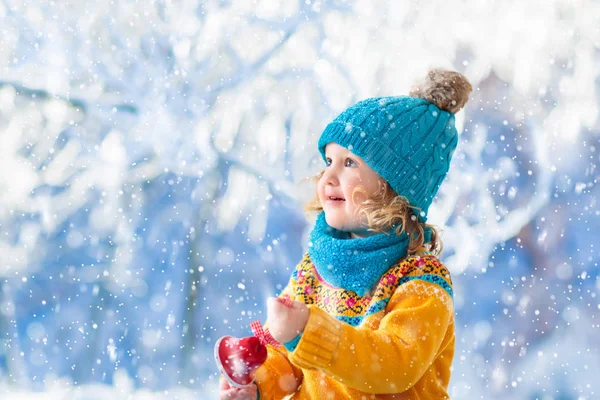 Kind aan het spelen in winterpark. Kinderen en sneeuw. — Stockfoto