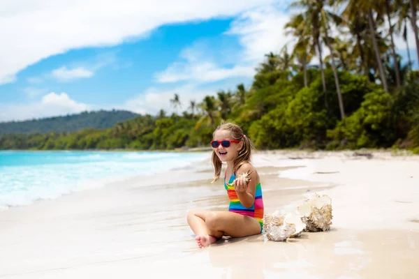 Criança na praia tropical. Criança com concha do mar . — Fotografia de Stock