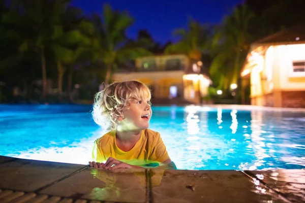 Kids in swimming pool at night — Stock Photo, Image