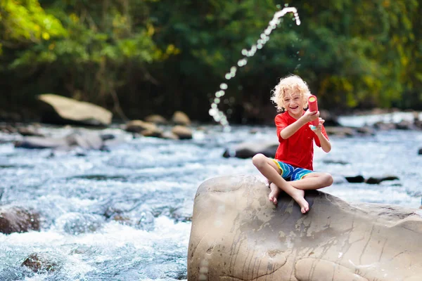 Child hiking in mountains. Kids at river shore. — Stock Photo, Image