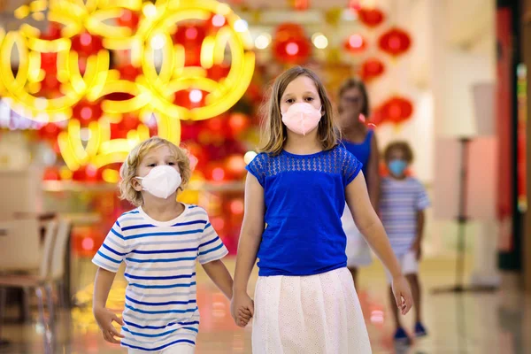 Family wearing face mask in shopping mall in Asia