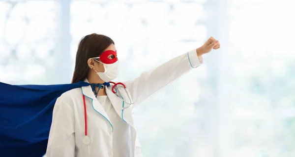 Asian doctor or nurse wearing surgical face mask in superhero cape. Medical staff during coronavirus outbreak in Asia. Super hero power for clinic and hospital personal.