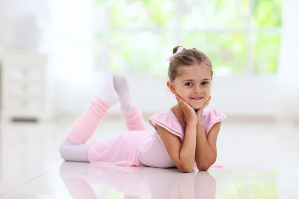 Ballet home training. Remote learning. Little ballerina in dance class. Cute girl in tutu and leotard learning to dance. Classic choreography for kids. Child dancer exercising. Online ballet course.