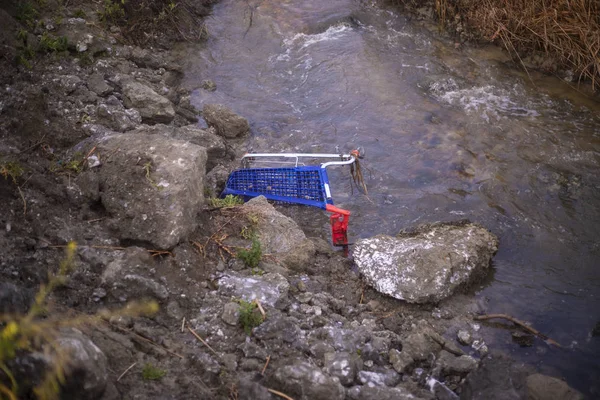 a car lying on a river pollution environment