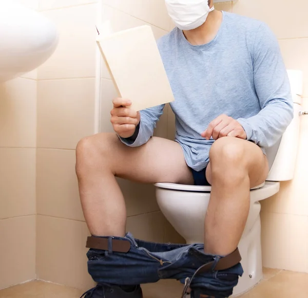 Man Sitting Bathroom Face Mask Reading Book Isolation Covid — Stock Photo, Image