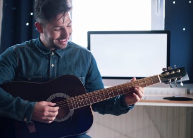 Gitar hocası, Teknoloji ve eğlence. Öğretmen nasıl enstrüman çalınacağını öğretiyor..
