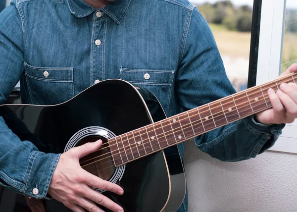 Guitar lessons or two musicians playing together, taken from behind a guitar