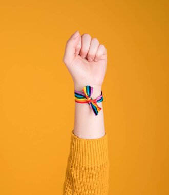 El yapımı gökkuşağı bileziği, LGBT, gay gururu, pastel sarısı arka planda