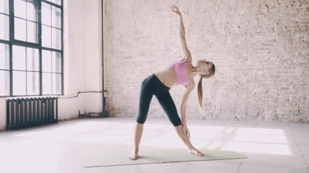 Mooie yoga meisje doet asana's in studio — Stockvideo