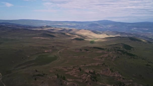 Baikal Valley spirits,Tazheran steppe, stone cliffs on the road. Aerial Summer — Stock Video