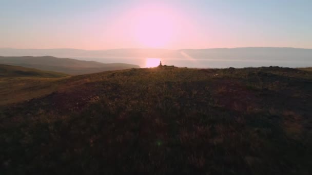 Aerial field of dry yellow grass. Steppe on Olkhon Island. Lake Baikal, Russia. Drone footage hills in the sunset — Stock Video